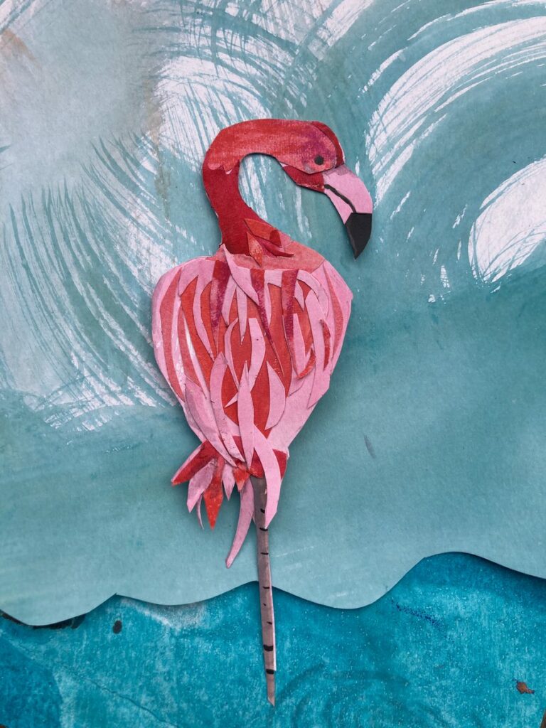 flamingo paper cut out on blue background