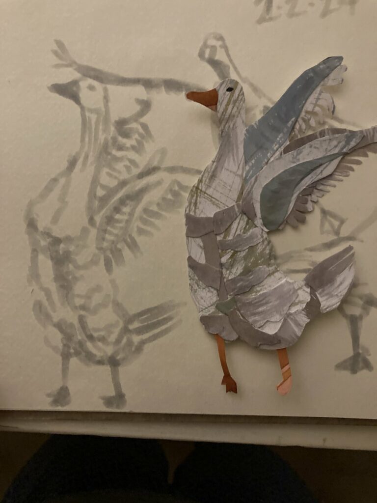 goose swatting his wings with them up in the back made of cut paper next to original drawing