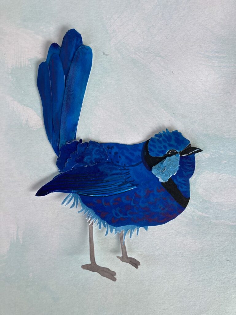 blue wren made of cut paper on light blue background